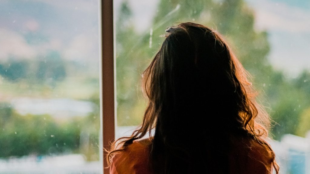 Closeup of girl looking out of a window
